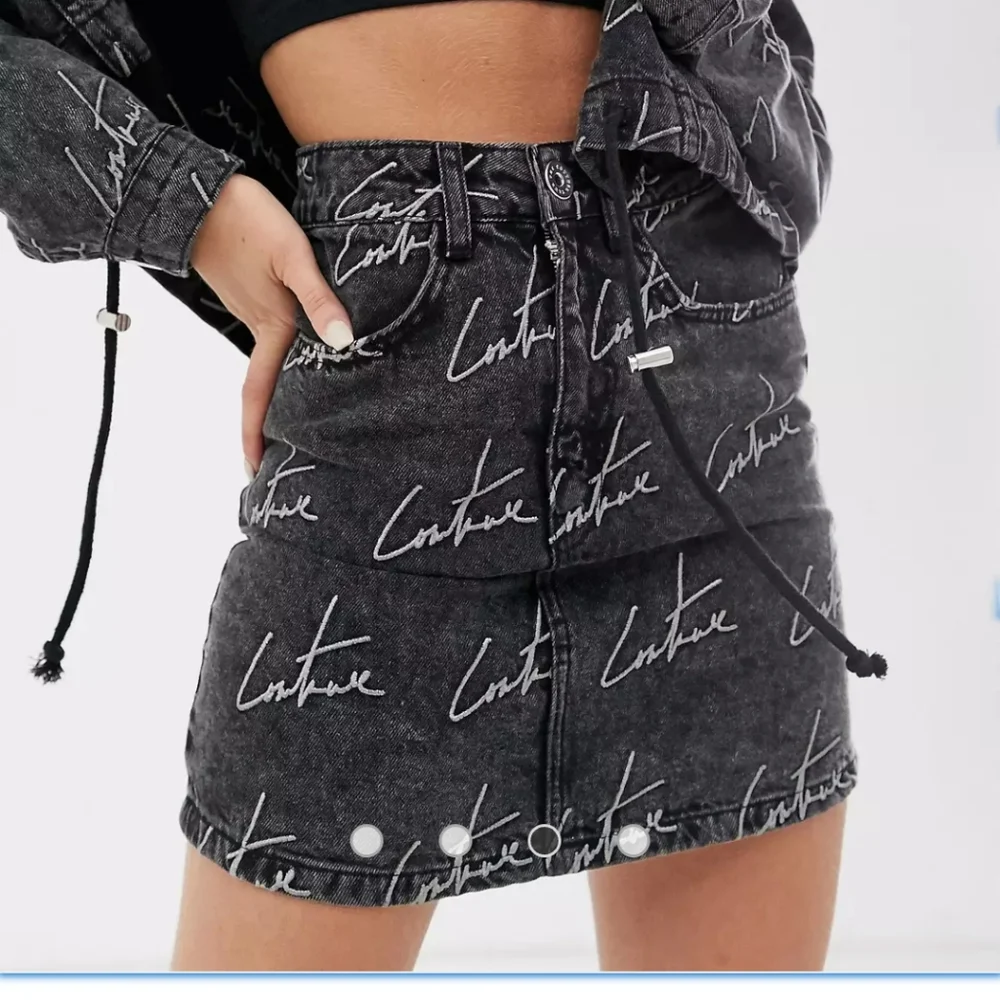 The couture Club Embroidery washed out black Jean Skirt. Size S.